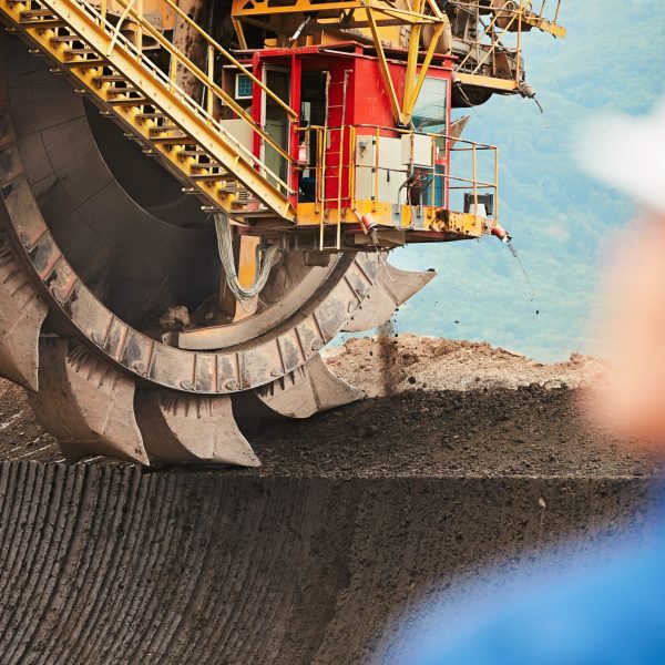 Coal mining in an open pit - Worker is looking on the huge excavator - industry in Czech Republic